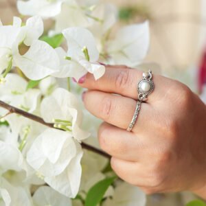 hand with double silver earrings