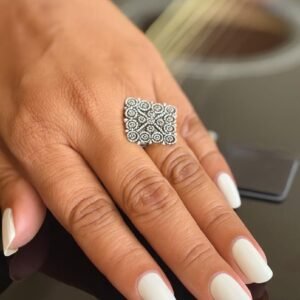 Square silver ring with a filigree design.